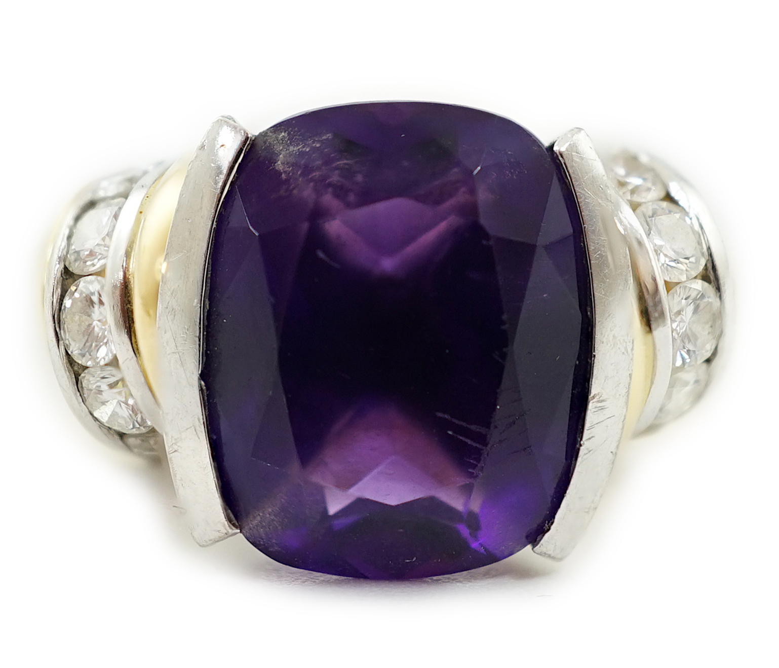 A modern 18ct gold and single stone cushion cut amethyst set dress ring, with ten stone round brilliant cut diamond set shoulders